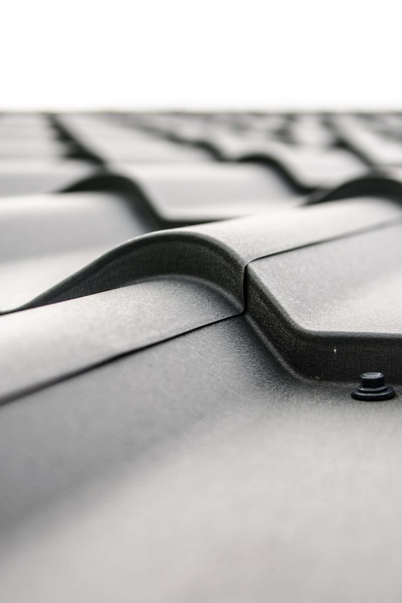 Close-up view of a metal roof's wavy design showcasing rivets and structural detail.